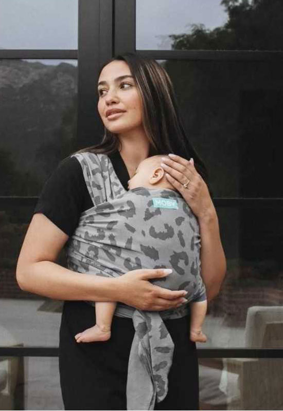 Mama trägt Baby im Classic Moby Wrap Night Leopard